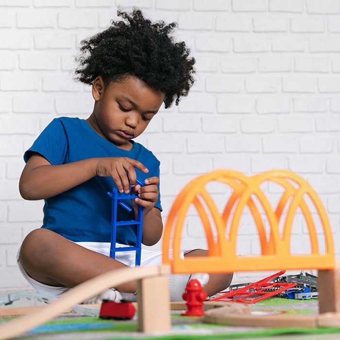 Happy black people African American child play toy at home